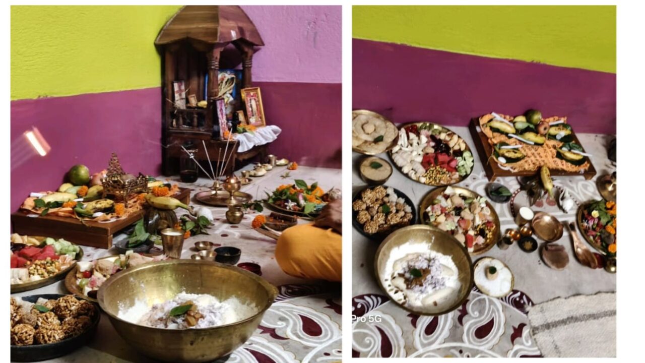 Traditional Lakshmi Puja 2025 setup at home with offerings, fruits, sweets, and puja items arranged on the floor.